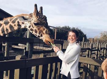 Woman petting a giraffe