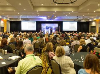 Attendees in a large ballroom at a conference